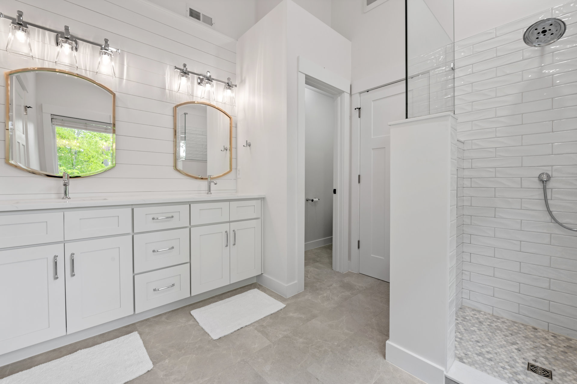 Bathroom after featuring chrome vanishes and crisp white tones
